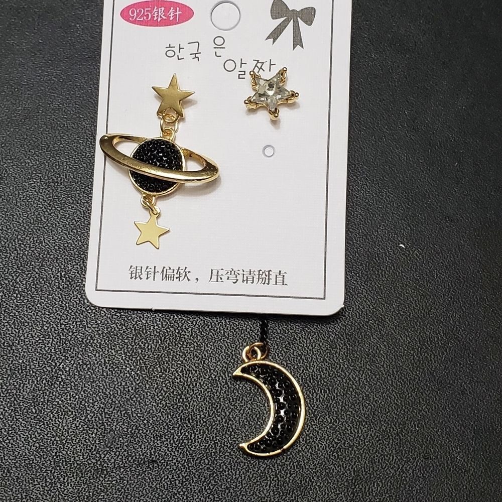 Gold tone stars and moon asymmetrical earrings